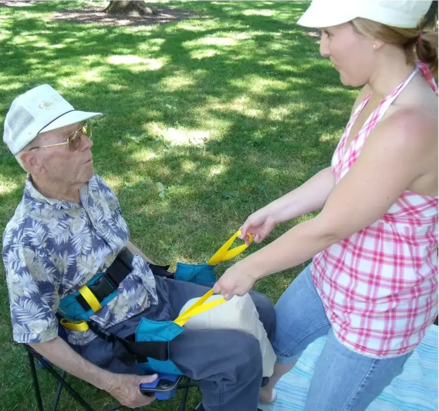 Caregiver assisting with the Ergotrans Harness outdoors