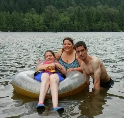Family floating on a lake tube together